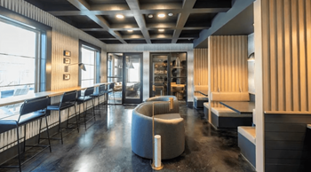 A modern room with a black floor and a striped wall.